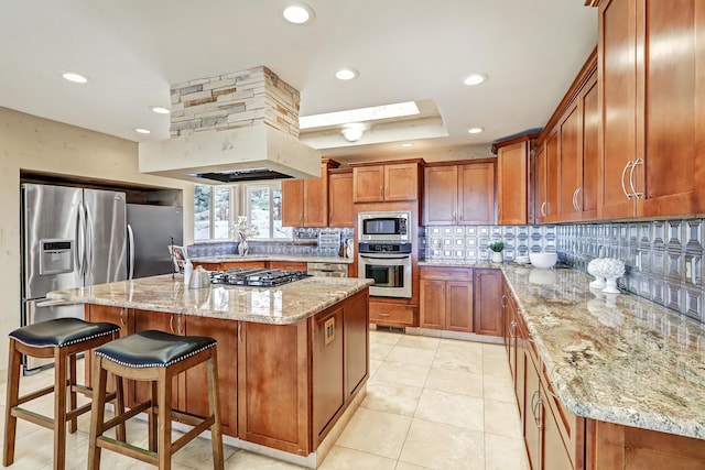 1106 Warm Sands Dr SE, Albuquerque, NM 87123 - kitchen with appliances with stainless steel finishes, brown cabinets, tasteful backsplash, light stone counters, and recessed lighting