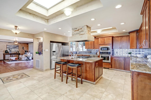1106 Warm Sands Dr SE, Albuquerque, NM 87123 - kitchen with a tray ceiling, stainless steel appliances, light stone countertops, tasteful backsplash, and recessed lighting