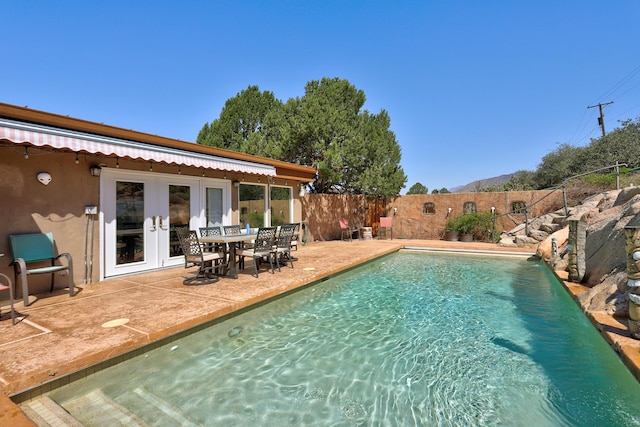 1106 Warm Sands Dr SE, Albuquerque, NM 87123 - view of swimming pool with french doors, a fenced backyard, a patio area, and outdoor dining area