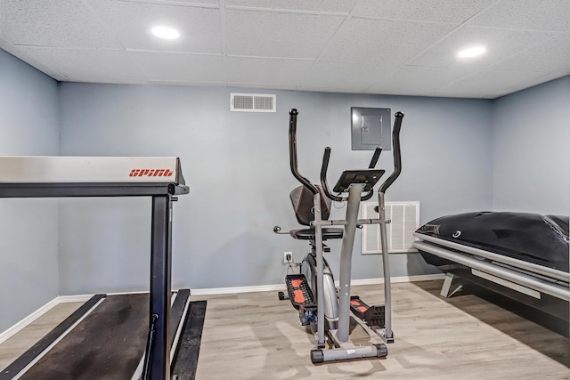 1106 Warm Sands Dr SE, Albuquerque, NM 87123 - exercise room featuring wood finished floors, baseboards, electric panel, a paneled ceiling, and recessed lighting