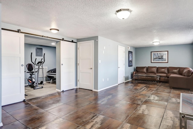 1106 Warm Sands Dr SE, Albuquerque, NM 87123 - living area with a barn door, a textured ceiling, baseboards, and electric panel