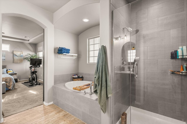 full bath with a shower stall, wood finished floors, a bath, and recessed lighting