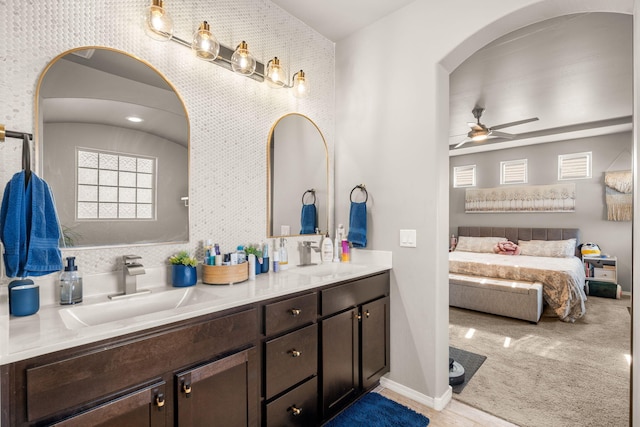 full bath featuring a ceiling fan, double vanity, and ensuite bathroom