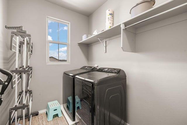 laundry room featuring washer and clothes dryer, wood finished floors, and baseboards