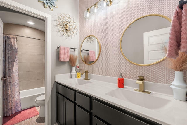 full bath featuring vanity, toilet, and shower / tub combo