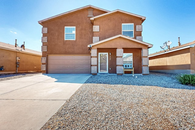 5727 Cibola Dr NE, Rio Rancho, NM 87144 - view of front facade featuring an attached garage, driveway, and stucco siding