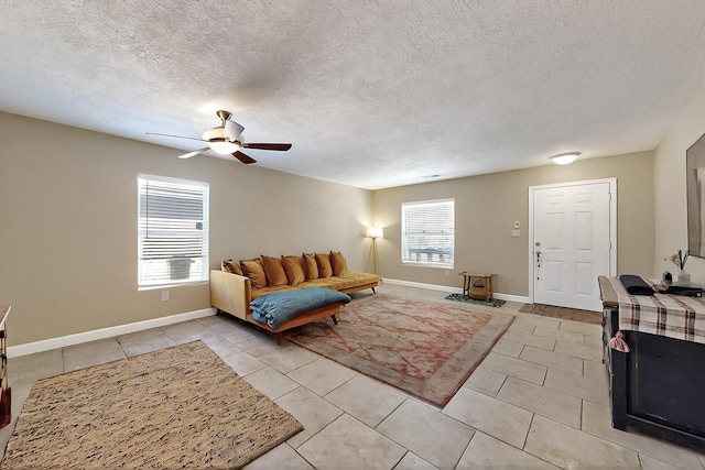 5727 Cibola Dr NE, Rio Rancho, NM 87144 - living area with ceiling fan, light tile patterned floors, and a textured ceiling