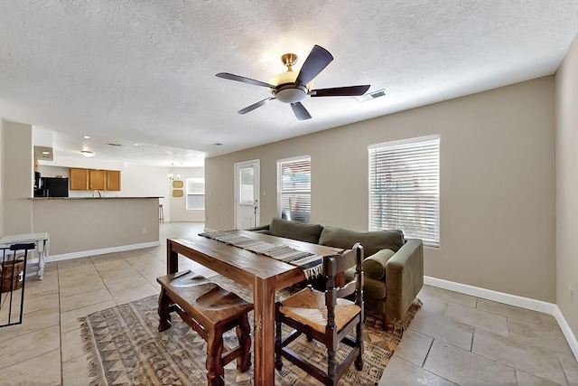 5727 Cibola Dr NE, Rio Rancho, NM 87144 - dining space featuring a ceiling fan, light tile patterned floors, and a textured ceiling