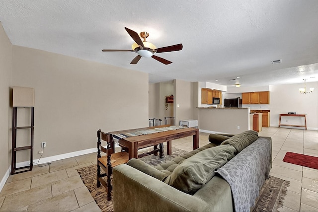 5727 Cibola Dr NE, Rio Rancho, NM 87144 - living room featuring light tile patterned flooring, ceiling fan, a chandelier, and a textured ceiling