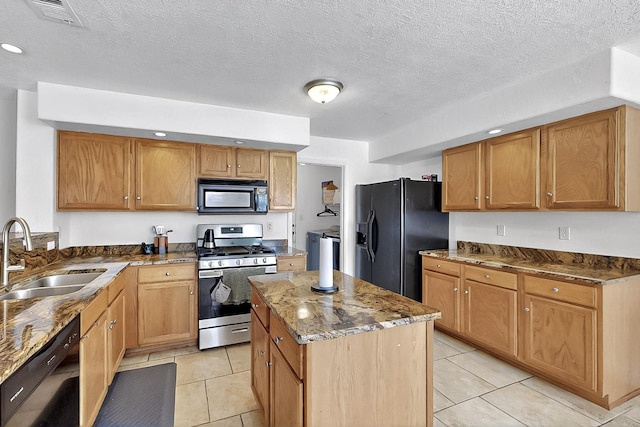 5727 Cibola Dr NE, Rio Rancho, NM 87144 - kitchen with black appliances, dark stone countertops, a kitchen island, and light tile patterned floors