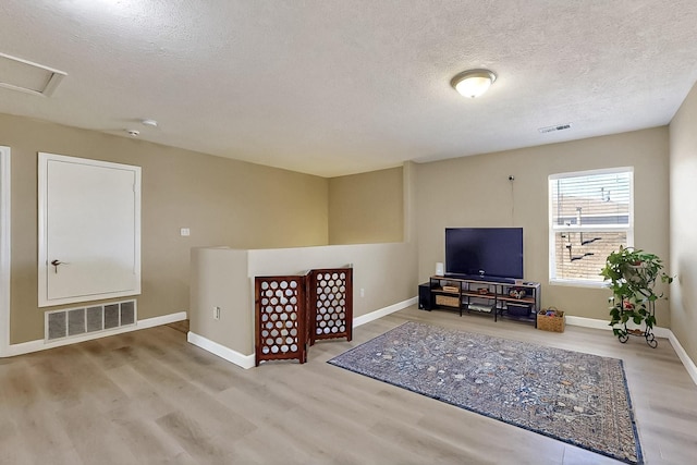 5727 Cibola Dr NE, Rio Rancho, NM 87144 - living room with wood finished floors, a textured ceiling, and attic access