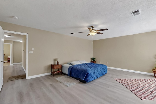5727 Cibola Dr NE, Rio Rancho, NM 87144 - bedroom featuring wood finished floors, a textured ceiling, and a ceiling fan