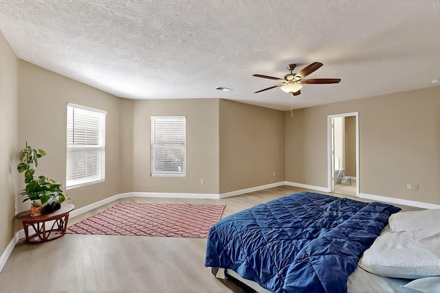 5727 Cibola Dr NE, Rio Rancho, NM 87144 - bedroom featuring wood finished floors, a ceiling fan, and a textured ceiling