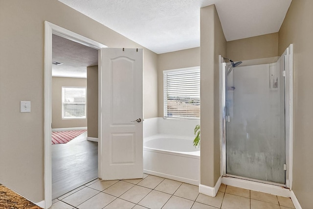 5727 Cibola Dr NE, Rio Rancho, NM 87144 - bathroom with a stall shower, a garden tub, and tile patterned flooring