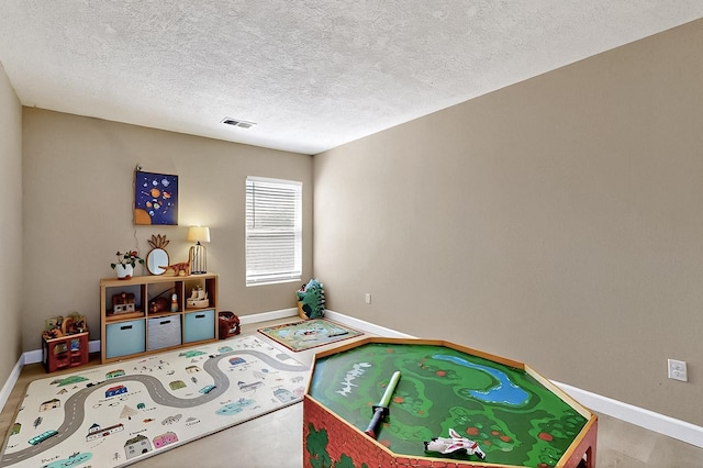 5727 Cibola Dr NE, Rio Rancho, NM 87144 - playroom featuring baseboards and a textured ceiling