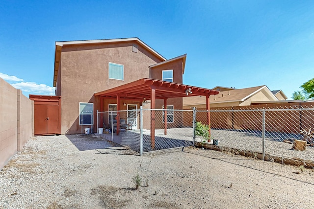 5727 Cibola Dr NE, Rio Rancho, NM 87144 - rear view of property with stucco siding, a patio, and a fenced backyard