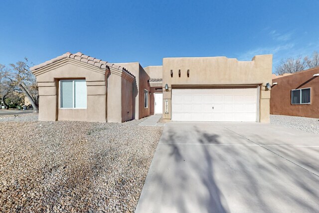 10216 Sand Sage Dr NW, Albuquerque, NM 87114 - adobe home with stucco siding, concrete driveway, and an attached garage