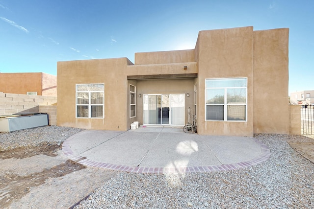 10216 Sand Sage Dr NW, Albuquerque, NM 87114 - back of house with stucco siding and a patio area