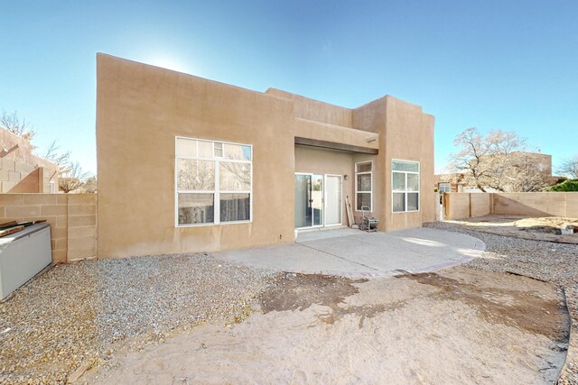 10216 Sand Sage Dr NW, Albuquerque, NM 87114 - back of house featuring a fenced backyard, a patio area, and stucco siding