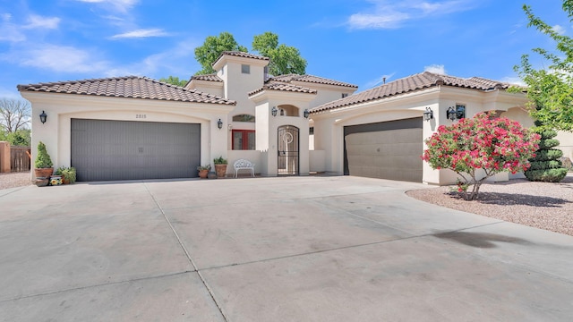 2815 Linda Pl SW, Albuquerque, NM 87105 - mediterranean / spanish-style house featuring an attached garage, driveway, stucco siding, and a tiled roof