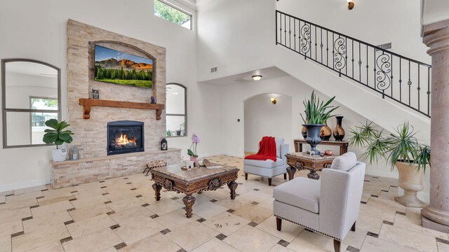 2815 Linda Pl SW, Albuquerque, NM 87105 - living area featuring a high ceiling, arched walkways, a fireplace, baseboards, and stairway