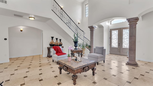 2815 Linda Pl SW, Albuquerque, NM 87105 - foyer featuring arched walkways, decorative columns, a high ceiling, baseboards, and light tile patterned floors