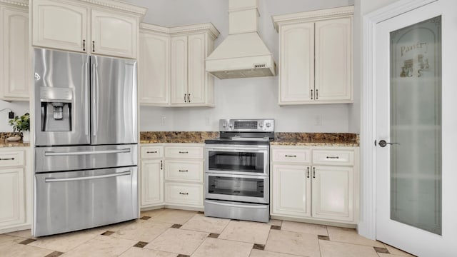 2815 Linda Pl SW, Albuquerque, NM 87105 - kitchen with stainless steel appliances, premium range hood, cream cabinetry, and dark stone countertops