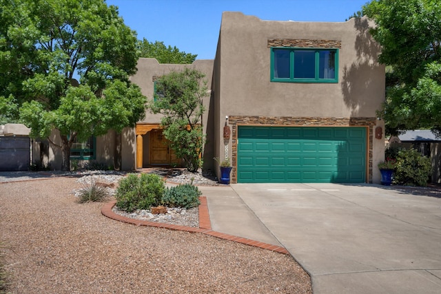 2408 Calle De Panza NW, Albuquerque, NM 87104 - adobe home with stucco siding, concrete driveway, stone siding, and a garage