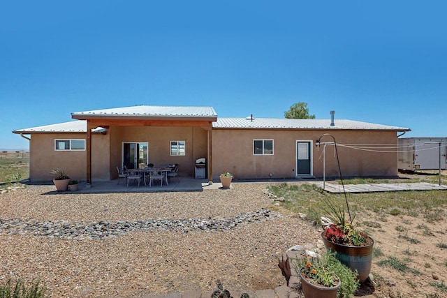 21 Camino No Mas, Stanley, NM 87056 - rear view of property featuring stucco siding, a patio area, and a metal roof