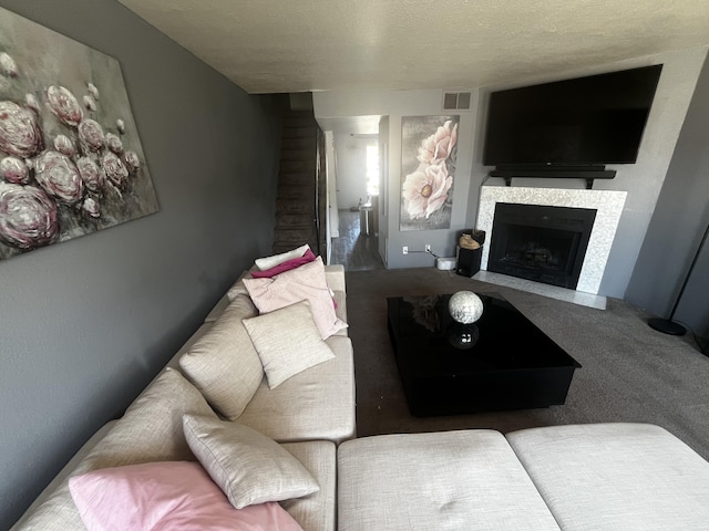 3301 Monroe St NE Unit D45, Albuquerque, NM 87110 - carpeted living room with a fireplace and a textured ceiling