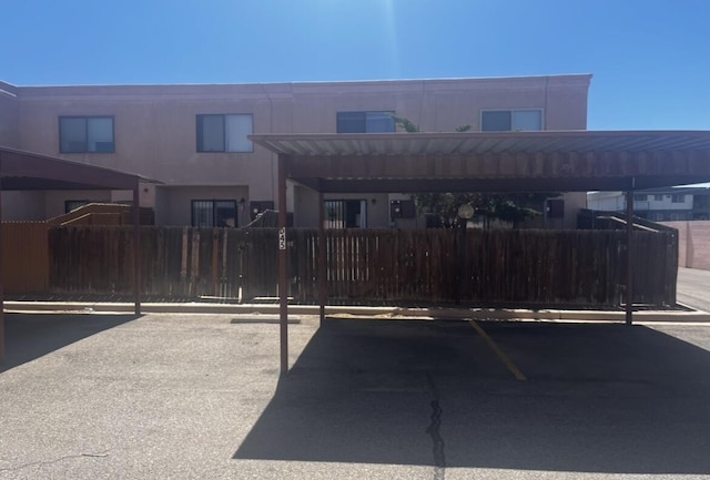 3301 Monroe St NE Unit D45, Albuquerque, NM 87110 - view of front of house featuring covered parking and fence