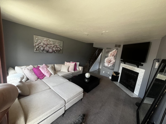 3301 Monroe St NE Unit D45, Albuquerque, NM 87110 - living area featuring carpet, a fireplace with flush hearth, stairs, and a textured ceiling