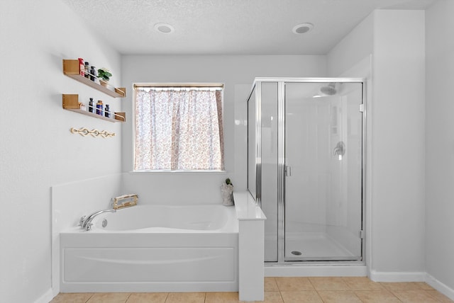 3515 Colina Serena Pl NE, Rio Rancho, NM 87124 - full bath featuring tile patterned floors, a garden tub, a stall shower, a textured ceiling, and baseboards