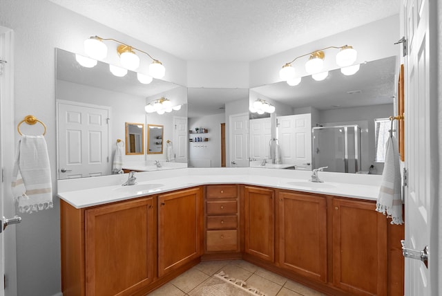 3515 Colina Serena Pl NE, Rio Rancho, NM 87124 - bathroom featuring tile patterned flooring, a textured ceiling, double vanity, and a stall shower