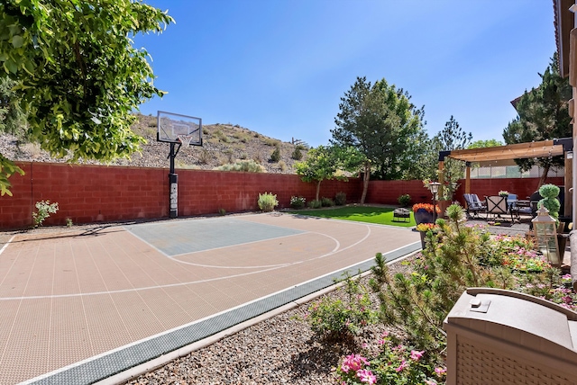 3515 Colina Serena Pl NE, Rio Rancho, NM 87124 - view of basketball court featuring basketball hoop, a fenced backyard, and a pergola