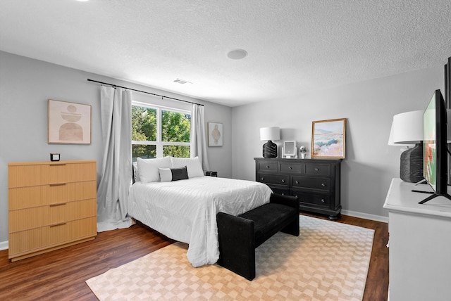 3515 Colina Serena Pl NE, Rio Rancho, NM 87124 - bedroom with dark wood finished floors, a textured ceiling, and baseboards