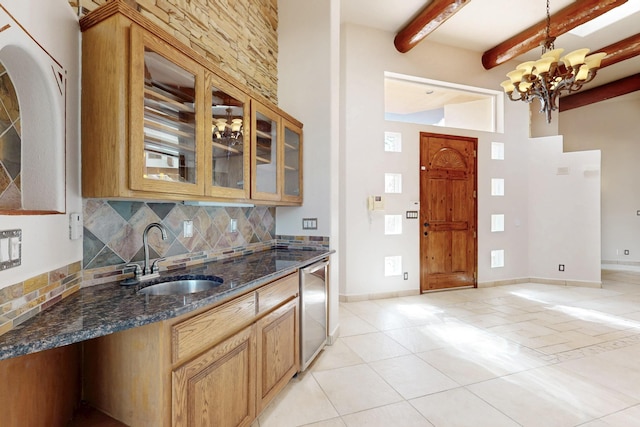 13401 Blue Flax Ct NE, Albuquerque, NM 87111 - kitchen featuring a sink, tasteful backsplash, light tile patterned flooring, beamed ceiling, and glass insert cabinets
