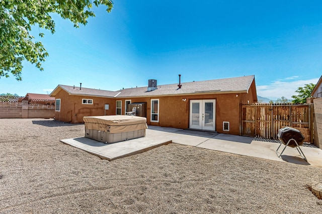 1905 Clearwater Loop NE, Rio Rancho, NM 87144 - back of house with a hot tub, french doors, a patio, a fenced backyard, and stucco siding