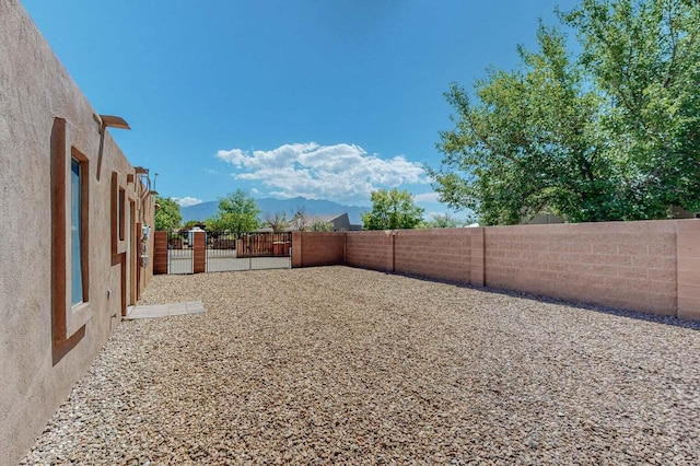501 Calle De La Angel, Bernalillo, NM 87004 - fenced backyard with a gate and a mountain view