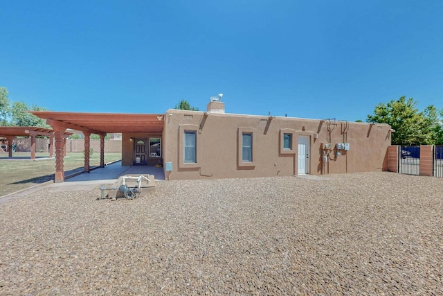 501 Calle De La Angel, Bernalillo, NM 87004 - back of property featuring stucco siding and a chimney