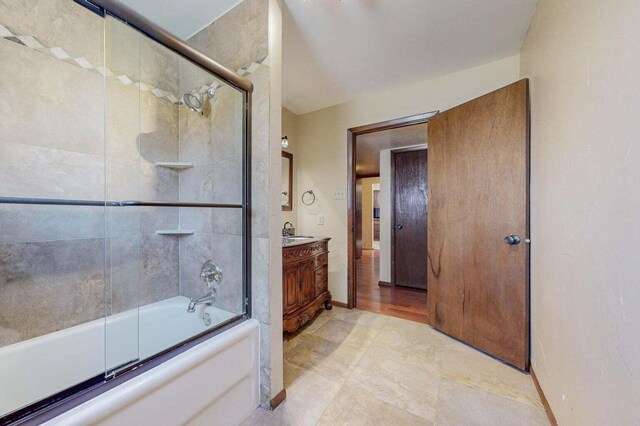 501 Calle De La Angel, Bernalillo, NM 87004 - bathroom featuring vanity, bath / shower combo with glass door, and baseboards