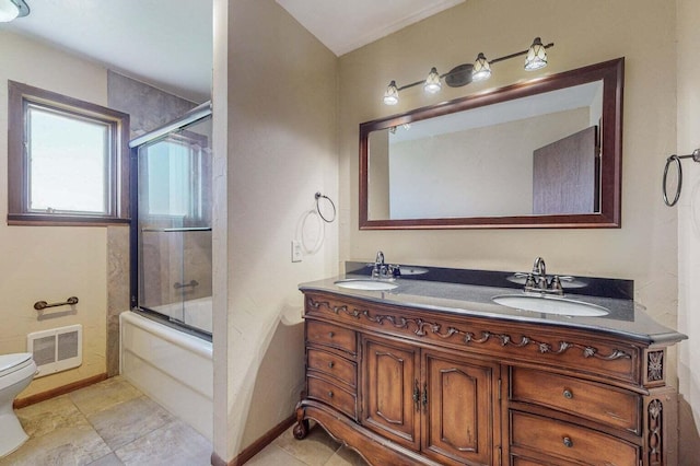 501 Calle De La Angel, Bernalillo, NM 87004 - bathroom featuring toilet, baseboards, enclosed tub / shower combo, and double vanity