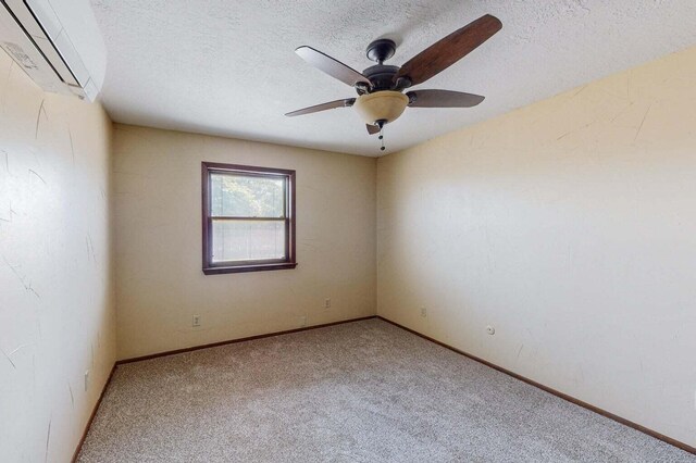 501 Calle De La Angel, Bernalillo, NM 87004 - spare room featuring a wall unit AC, carpet floors, a ceiling fan, a textured ceiling, and baseboards