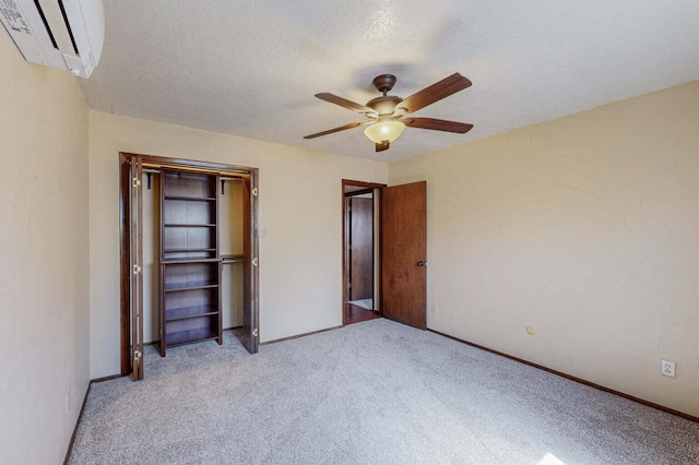 501 Calle De La Angel, Bernalillo, NM 87004 - unfurnished bedroom with an AC wall unit, light colored carpet, baseboards, and a closet