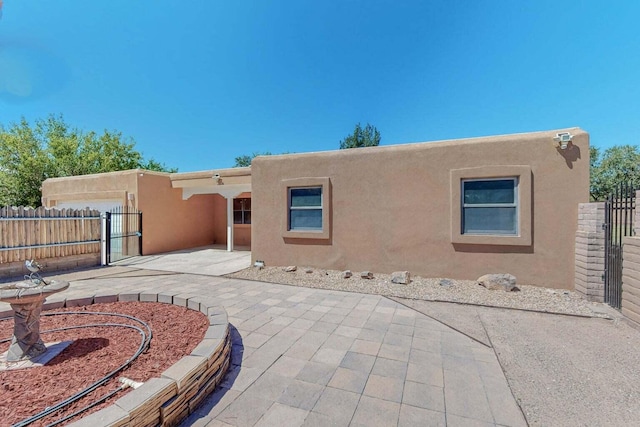 501 Calle De La Angel, Bernalillo, NM 87004 - rear view of house with a patio, stucco siding, and a gate