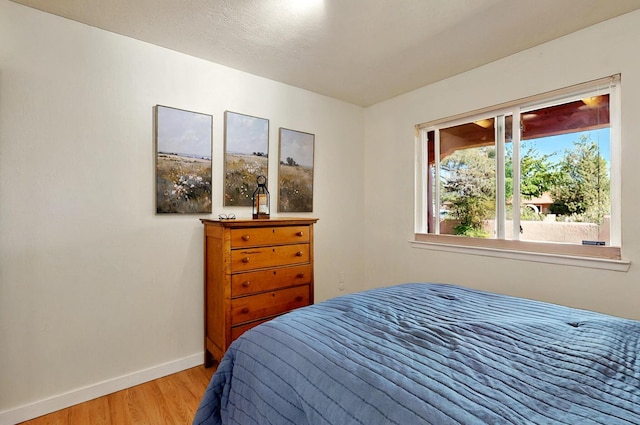 9737 Academy St NW, Albuquerque, NM 87114 - bedroom featuring light wood-style floors and baseboards