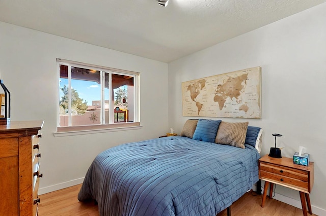 9737 Academy St NW, Albuquerque, NM 87114 - bedroom with light wood-style floors and baseboards