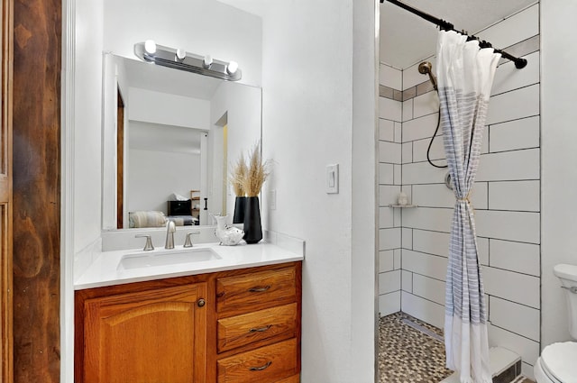 9737 Academy St NW, Albuquerque, NM 87114 - bathroom with toilet, ensuite bath, tiled shower, and vanity