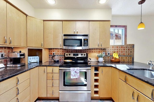 9737 Academy St NW, Albuquerque, NM 87114 - kitchen featuring appliances with stainless steel finishes, a sink, light brown cabinetry, and dark stone counters