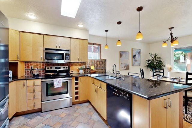 9737 Academy St NW, Albuquerque, NM 87114 - kitchen with stainless steel appliances, a sink, a peninsula, light brown cabinets, and a textured ceiling
